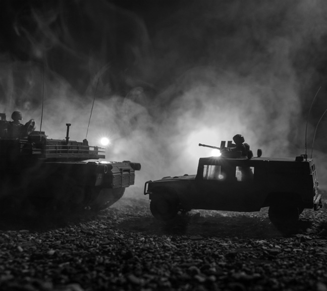 photo of military tanks with smoke from fire